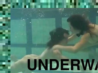 Friends swim naked underwater