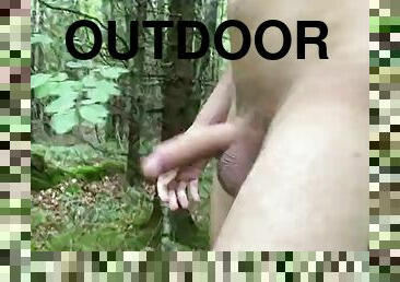 Horny guy walks through the woods with a boner