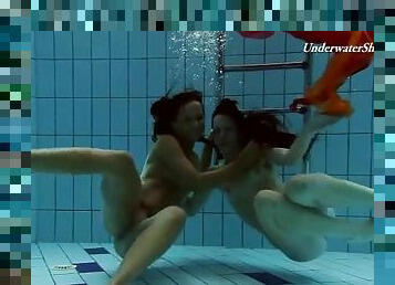 Two beautiful girls swim in the nude