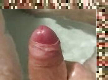 Stroking my cock in the bath