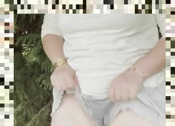 Girl has outdoor piss accident in grey shorts