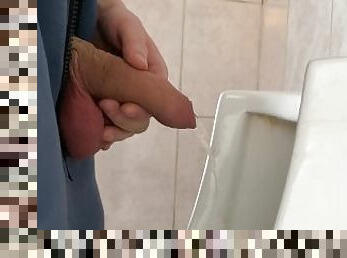 A guy pisses in a public urinal from an uncut penis without opening it 4K