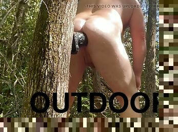 Huge dildo mounted on a tree