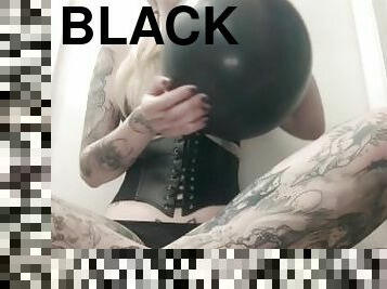 Blowing up big black balloon