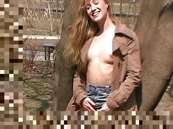 Sexy chick shows off her tits outdoors