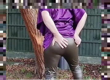 Hot satin hoodie and tight shiny leggings outdoors