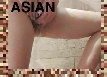 Chubby Asian girl playing with her wet hairy pussy in the bathroom