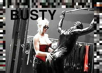 Busty corset mistress dominates latex slave