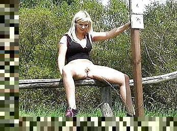 Tanned Blonde Babe Sits On Fence To Piss