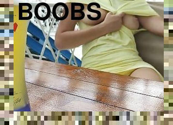 Alice bares her boobs in a cafe on the street and a little fingering under the table