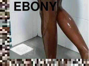 Ebony in wet pantyhose in the shower.