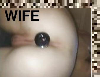 The wife inserts anal plug