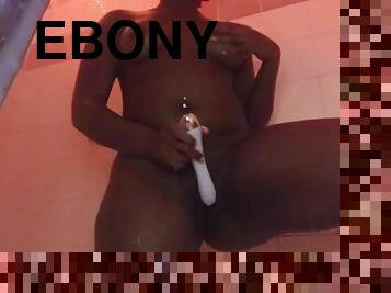 Ebony toys wet pussy in the shower