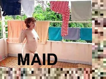 Naked laundry. The maid is drying clothes in the laundry.