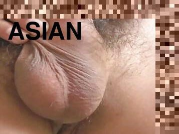 Asian guy with straw hat records while stroking his hairy dick