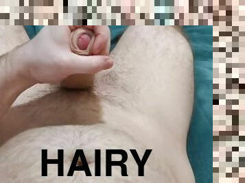 Huge cumshot on hairy masculine guy.