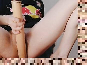Sporty girl fucks herself with her baseball bat