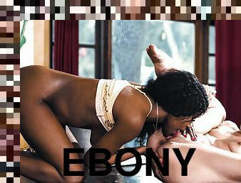 Alex Coal and ebony Jezabel Vessir have lesbian sex on the table