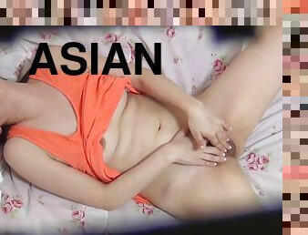 Pretty brunette Asian teen rubs clitoris in solo masturbation scene