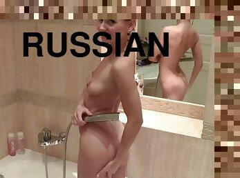 Hot Russian brunette takes a shower and rubs pussy and ass sexy nude