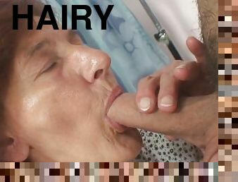 Hairy mature tailoress sucks and rides client's cock