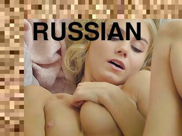Blond Russian babe in flirtatious lingerie fingers her vagina