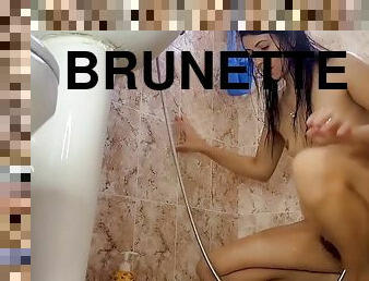 Slim brunette pumped up her belly with a shower for this. belly inflation