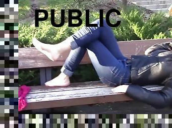 Hot Diana is resting on a bench in a really crowded park, with her pink socks. She chooses to