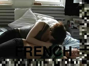 Two teenagers touch each other in their bedroom