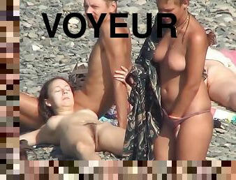 Voyeur watching nude babes at the beach