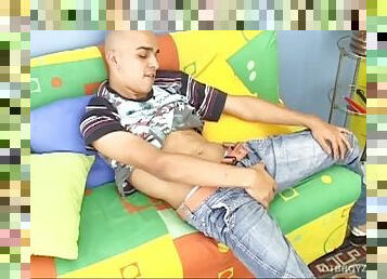 Perverted Latino skinhead Cristobal sits on the couch and strips for his jerk off show. Naked and hard, the boy shoves a candle up his ass.