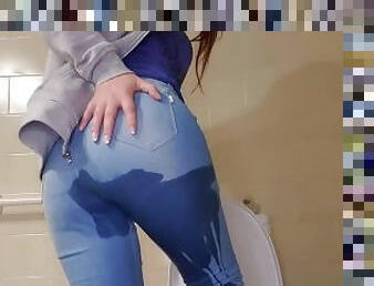 Girl with great ass peeing in her jean pants and playing with her pussy