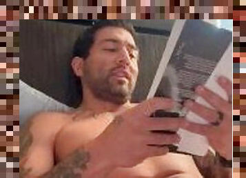 Tattooed sexy man with big enough dick does some naughty reading in the morning.