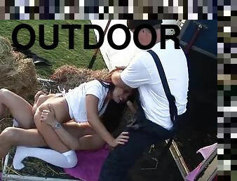 Loud moans echo in the outdoor fair as the brunette and the blonde are fucked