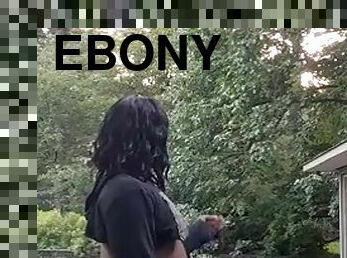 Ebony crossdresser enjoys a smoke outside and gets naked