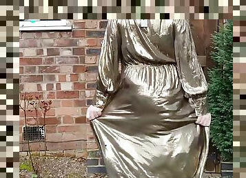 Sissy crossdresser outdoors in gold metallic shiny dress