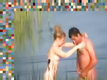 Voyeur porn of couple fucking in lake