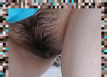 Hairy pussy is getting fully wet from urine