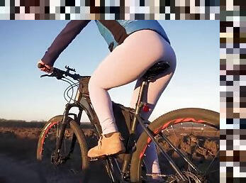 Japanese teen rides a bike and shows off her ass in tight leggings