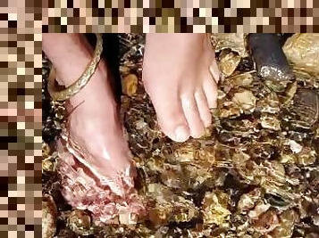 Walking barefoot in the river. Hairy legs. Ankles jewelery.