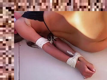 Chrissy tied up and gagged on a boat