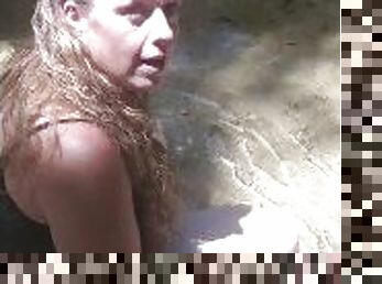 Country Girl Crawling On Her Hands and Knees In Water At Popular Spring Creek