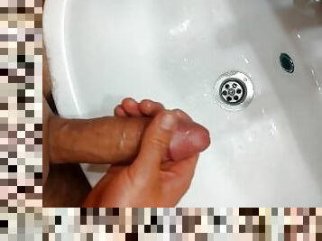Young man masturbates at the sink and cumshot