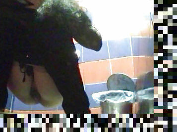 Dressed in black babe is peeing on the spy cam