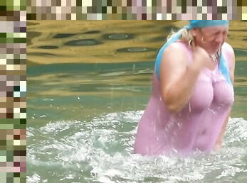 Mature Russian women swim in the river