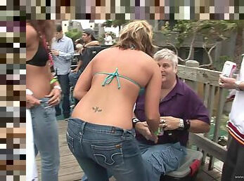 Cuddly amateurs in jeans and bikinis with piercing having fun outdoor as they get drunk