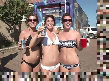 Arousing amateurs in glasses getting drunk in public at a beach party outdoor