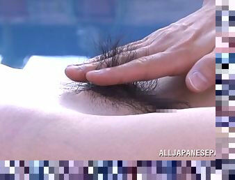 Voluptuous Japanese MILF having her hairy pussy shaved at the pool in close up shoot