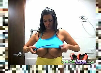 Chloe Veria tries on sports bras in bathroom